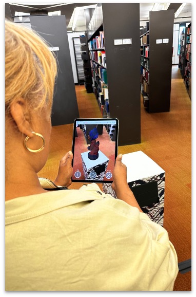 Library installation image showing the exhibition's augmented reality interpretation layer.