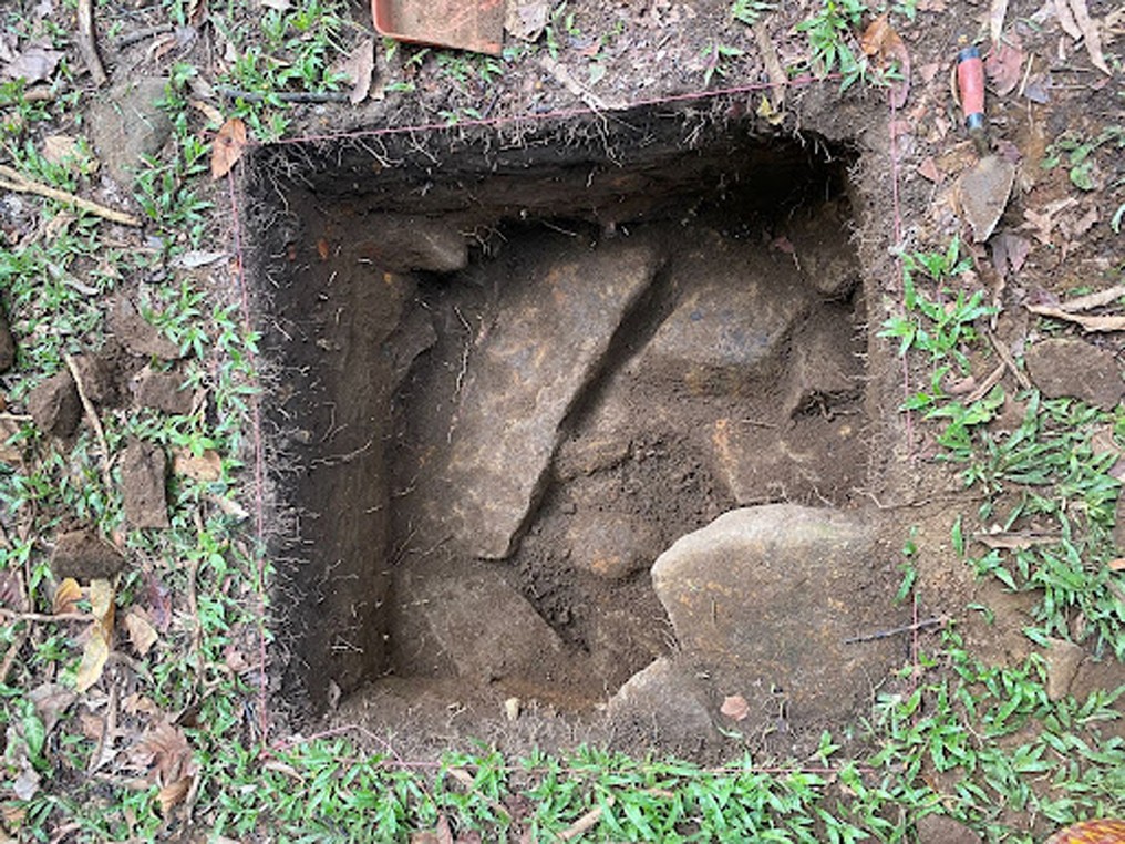 Overhead view of excavation Unit 4 on Providence Island, with exposed soil and large rocks, during the 2022 BAHA field season.